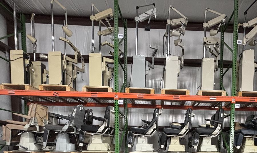 Ophthalmic instrument stands above rows of exam chairs